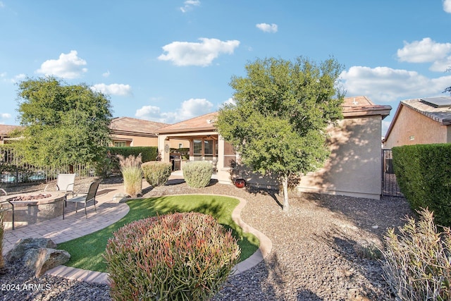 back of house featuring a patio area and a fire pit