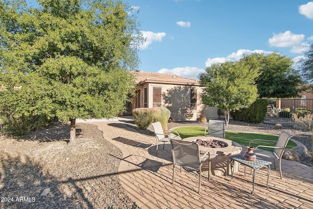 view of patio / terrace featuring an outdoor fire pit