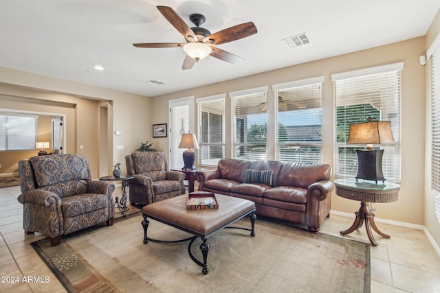 living room featuring ceiling fan, plenty of natural light, and light tile patterned floors