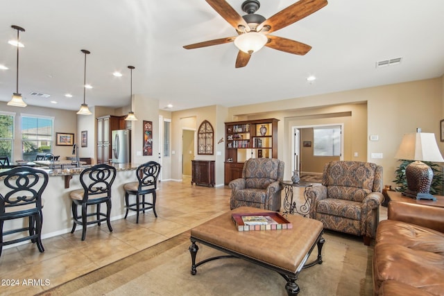 tiled living room featuring ceiling fan