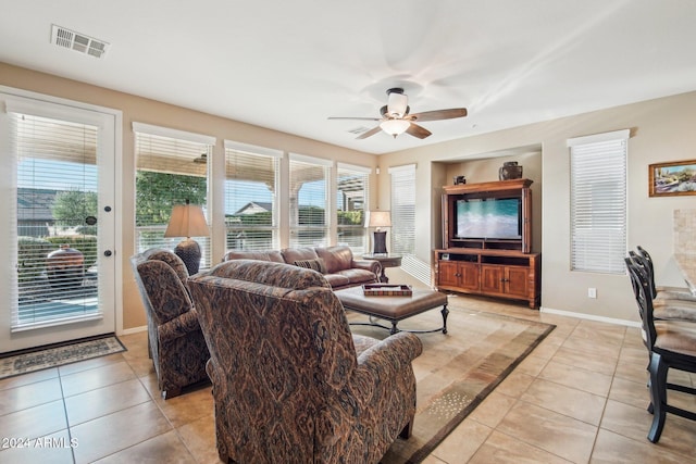 tiled living room featuring plenty of natural light and ceiling fan