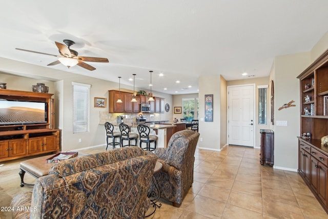 living room featuring ceiling fan and light tile patterned flooring