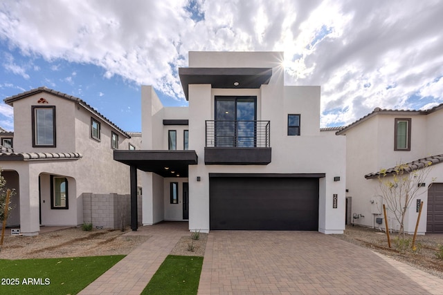 view of front of home with a garage and a balcony