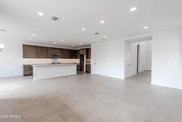 unfurnished living room featuring sink