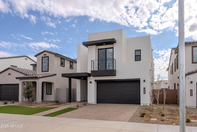 view of front of house with a garage and a balcony