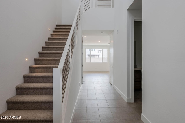 stairs featuring tile patterned flooring