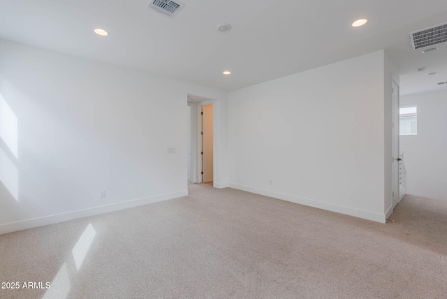 empty room featuring light colored carpet