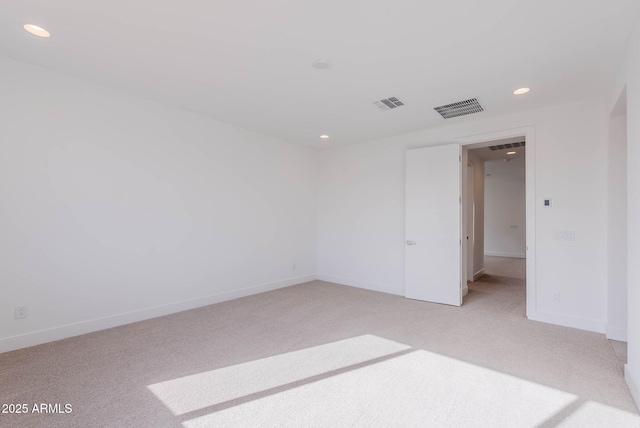 spare room with light colored carpet