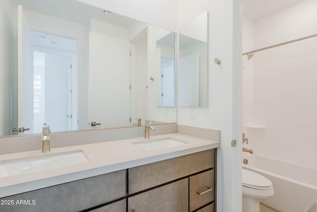 full bathroom featuring toilet, vanity, and  shower combination