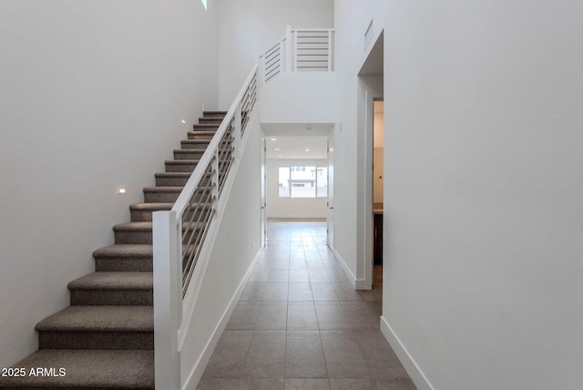 staircase with a towering ceiling