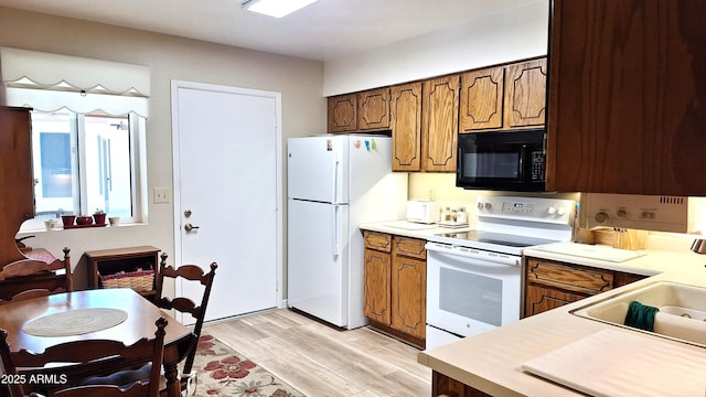 2064 S Farnsworth Dr Unit 38, Mesa, AZ 85209 - kitchen featuring white appliances, light countertops, a sink, and light wood-style flooring