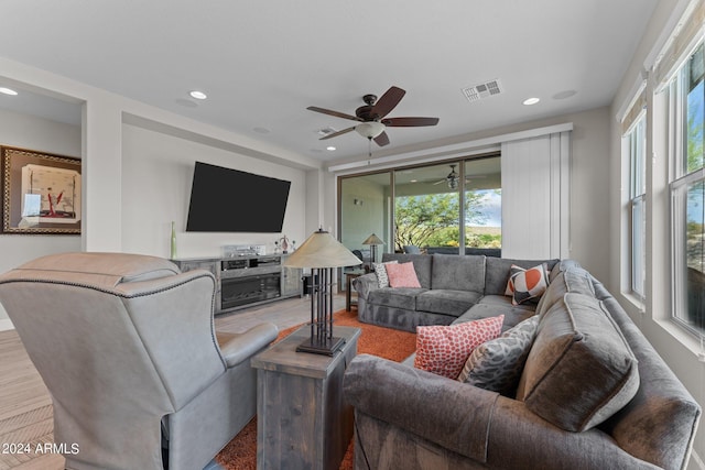 living room featuring a ceiling fan, visible vents, a wealth of natural light, and recessed lighting