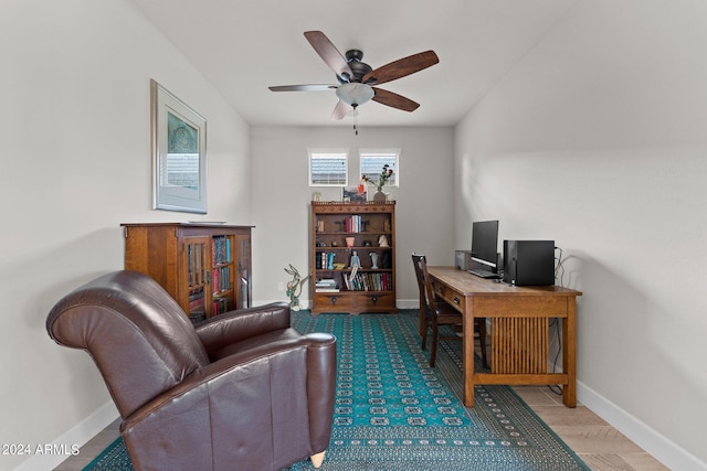 office area featuring ceiling fan and baseboards