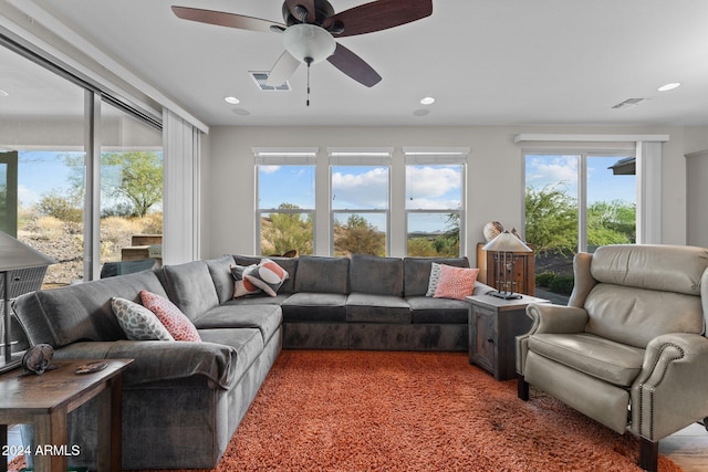 living area featuring visible vents and recessed lighting