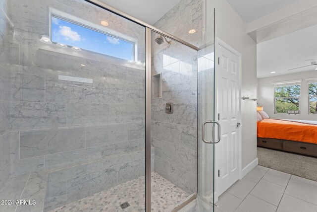 ensuite bathroom with a stall shower, tile patterned flooring, and connected bathroom