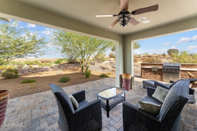 view of patio / terrace featuring outdoor lounge area, an outdoor kitchen, ceiling fan, and a grill