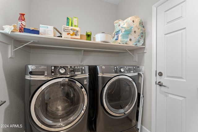 laundry room featuring washing machine and dryer and laundry area