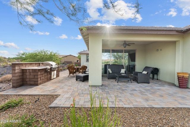 view of patio featuring ceiling fan, an outdoor living space, exterior kitchen, and grilling area