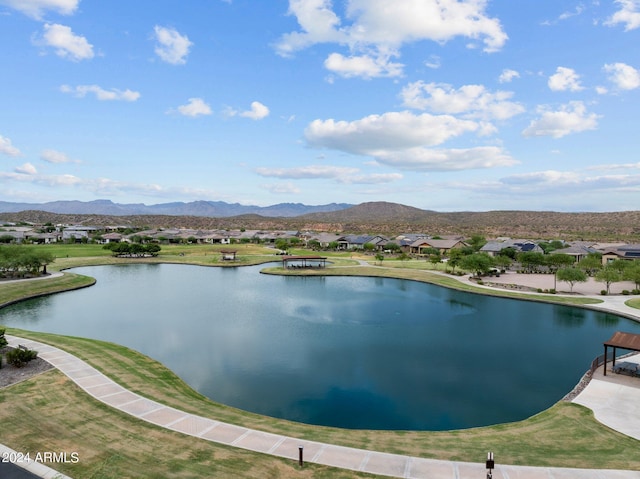 view of water feature with a residential view and a mountain view