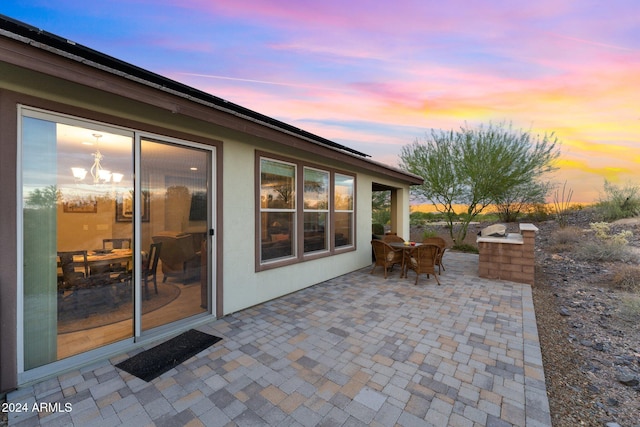 patio terrace at dusk featuring outdoor dining area