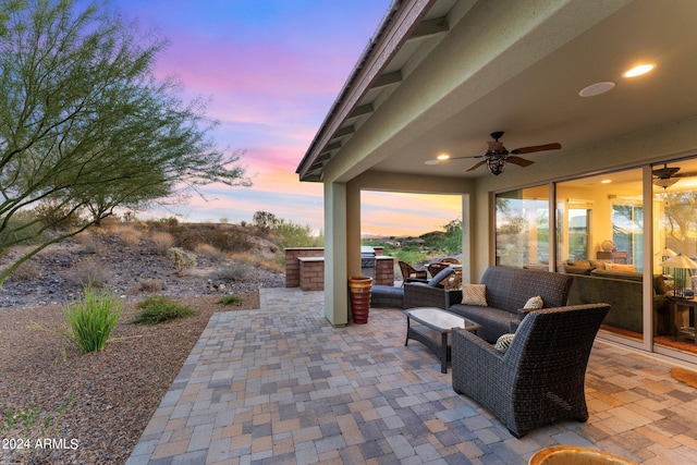 view of patio / terrace with a ceiling fan, an outdoor living space, and area for grilling