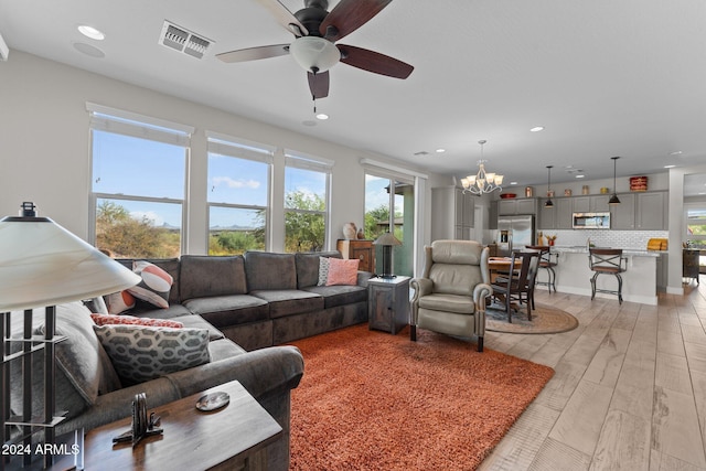 living area with light wood-type flooring, visible vents, and recessed lighting