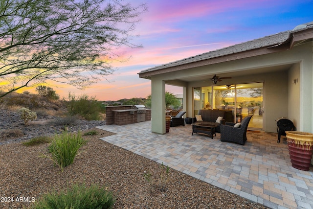 patio terrace at dusk featuring an outdoor living space, area for grilling, and a ceiling fan