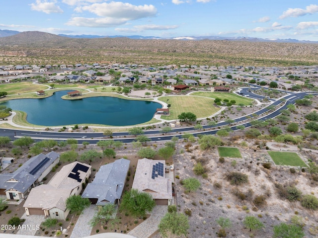 drone / aerial view with a water and mountain view and a residential view