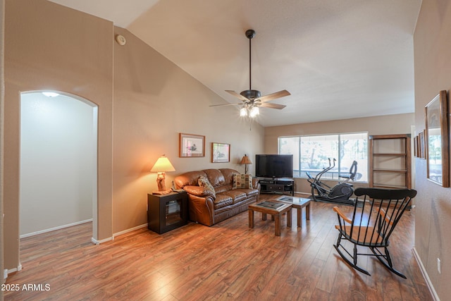 living room with hardwood / wood-style flooring, high vaulted ceiling, and ceiling fan