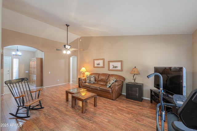 living room with vaulted ceiling, wood-type flooring, and ceiling fan