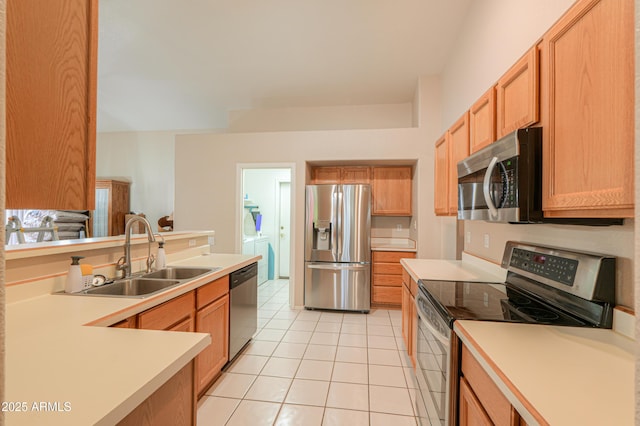 kitchen featuring appliances with stainless steel finishes, sink, and light tile patterned floors