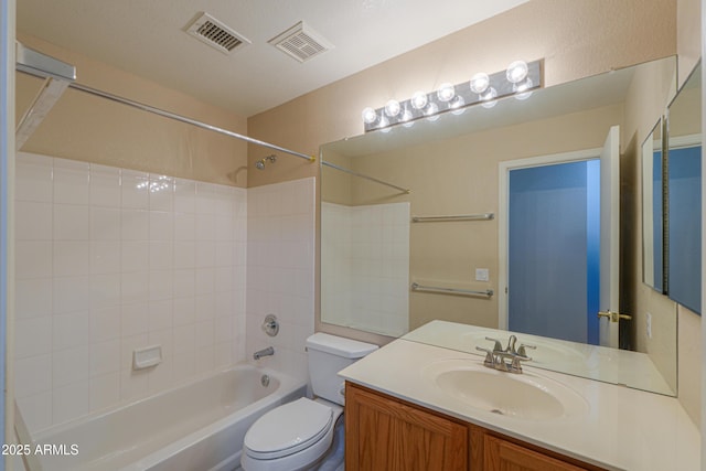 full bathroom with tiled shower / bath, vanity, and toilet