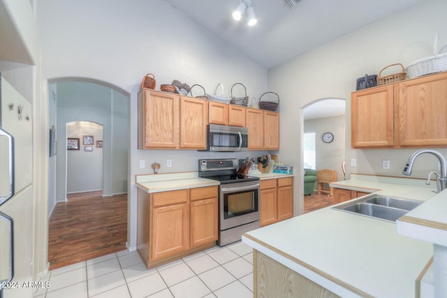 kitchen with light tile patterned flooring, stainless steel appliances, sink, and light brown cabinets