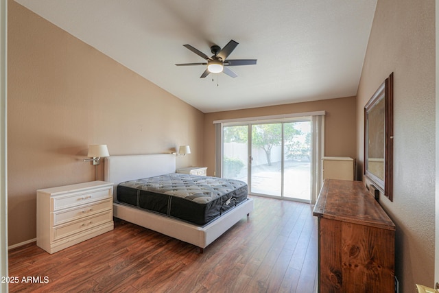 bedroom featuring vaulted ceiling, dark wood-type flooring, access to exterior, and ceiling fan