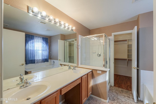 bathroom featuring vanity and independent shower and bath