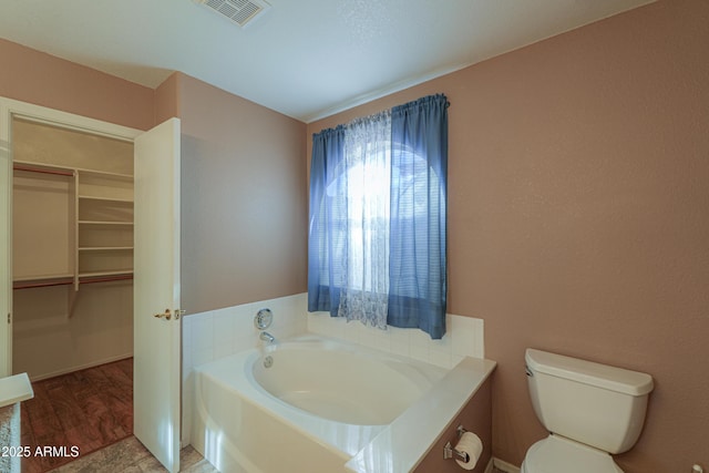 bathroom with a bathing tub and toilet