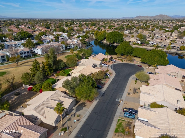 birds eye view of property with a water and mountain view