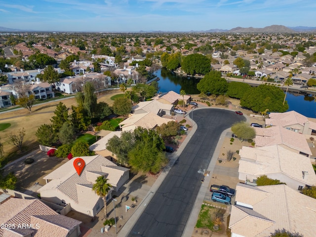 birds eye view of property featuring a water and mountain view