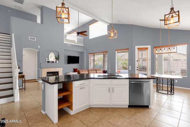 kitchen featuring sink, white cabinetry, hanging light fixtures, a center island with sink, and stainless steel dishwasher