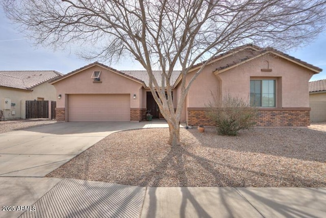 view of front of home with a garage, brick siding, driveway, and stucco siding