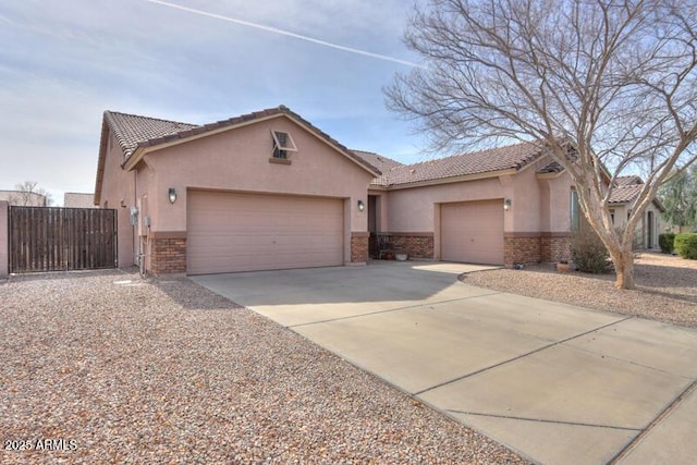 view of front of property with a garage, stucco siding, driveway, and brick siding