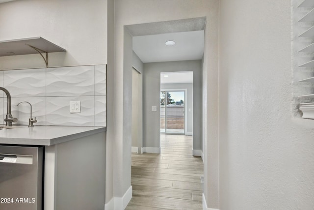 hall with wood-type flooring and sink