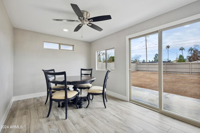 dining space with light hardwood / wood-style floors and ceiling fan