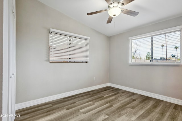 spare room with hardwood / wood-style floors, ceiling fan, and vaulted ceiling