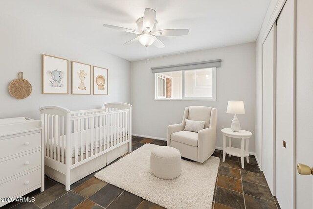 8301 E Indianola Ave, Scottsdale, AZ 85251 - bedroom with a nursery area, a ceiling fan, a closet, and baseboards