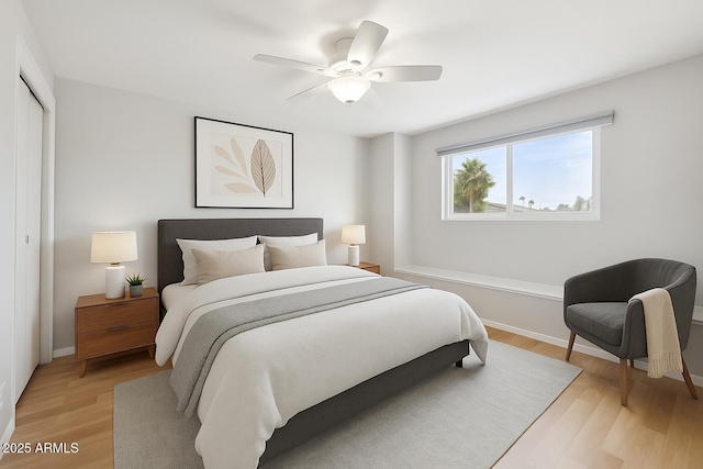8301 E Indianola Ave, Scottsdale, AZ 85251 - bedroom featuring light wood-style flooring, baseboards, ceiling fan, and a closet