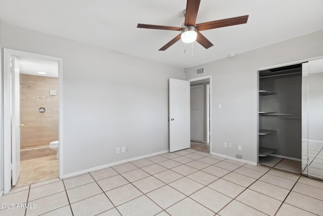 8301 E Indianola Ave, Scottsdale, AZ 85251 - unfurnished bedroom featuring light tile patterned floors, a closet, and baseboards
