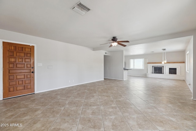 8301 E Indianola Ave, Scottsdale, AZ 85251 - unfurnished living room featuring ceiling fan, light tile patterned floors, and baseboards