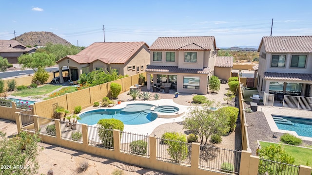 view of swimming pool with a mountain view and a patio