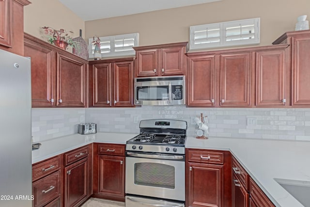 kitchen with decorative backsplash and stainless steel appliances